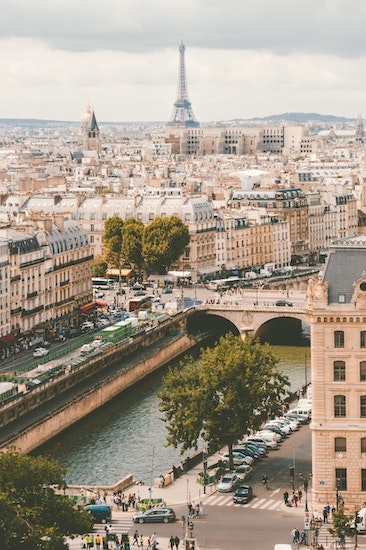 Overview photo of Paris, featuring the river, buildings, and the Eiffel Tower in the distance