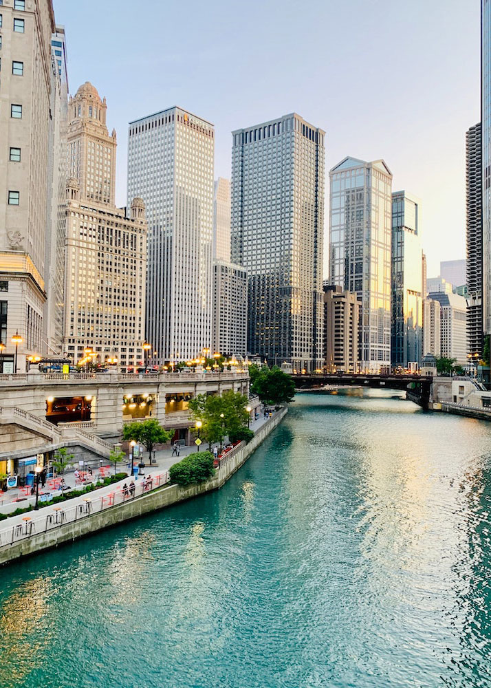 Chicago river, riverwalk, and buildings during daytime.