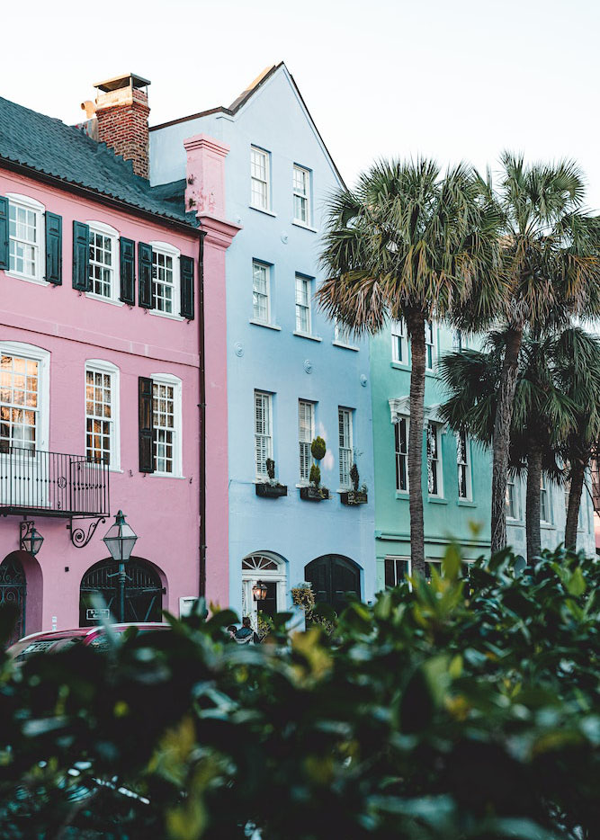 ooden fencing and sandly pathway leading to blue ocean